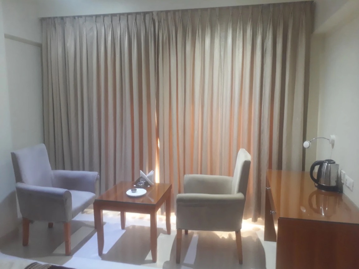 Premium room sitting area with armchairs